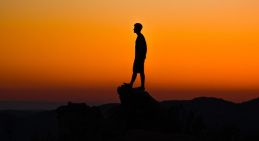 man on a rock cliff